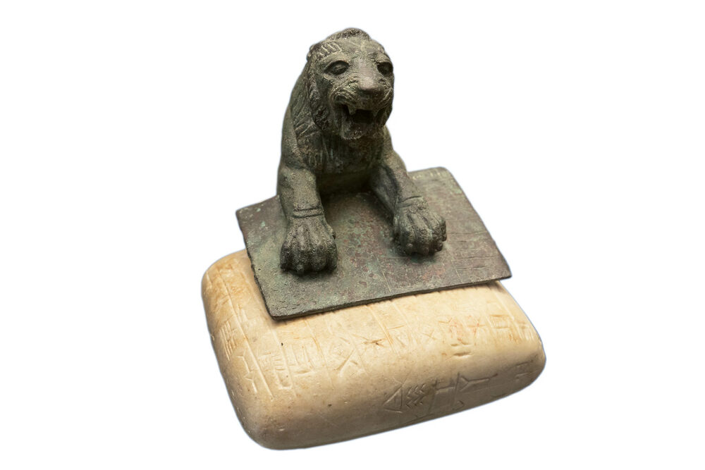 Lion of Urkesh with white tablet inscribed with Hurrian inscription