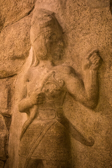 hittite king / god wearing short kilt with a dagger and carrying an axe